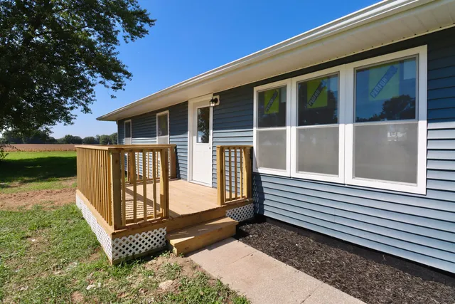 a view of a house with backyard and deck