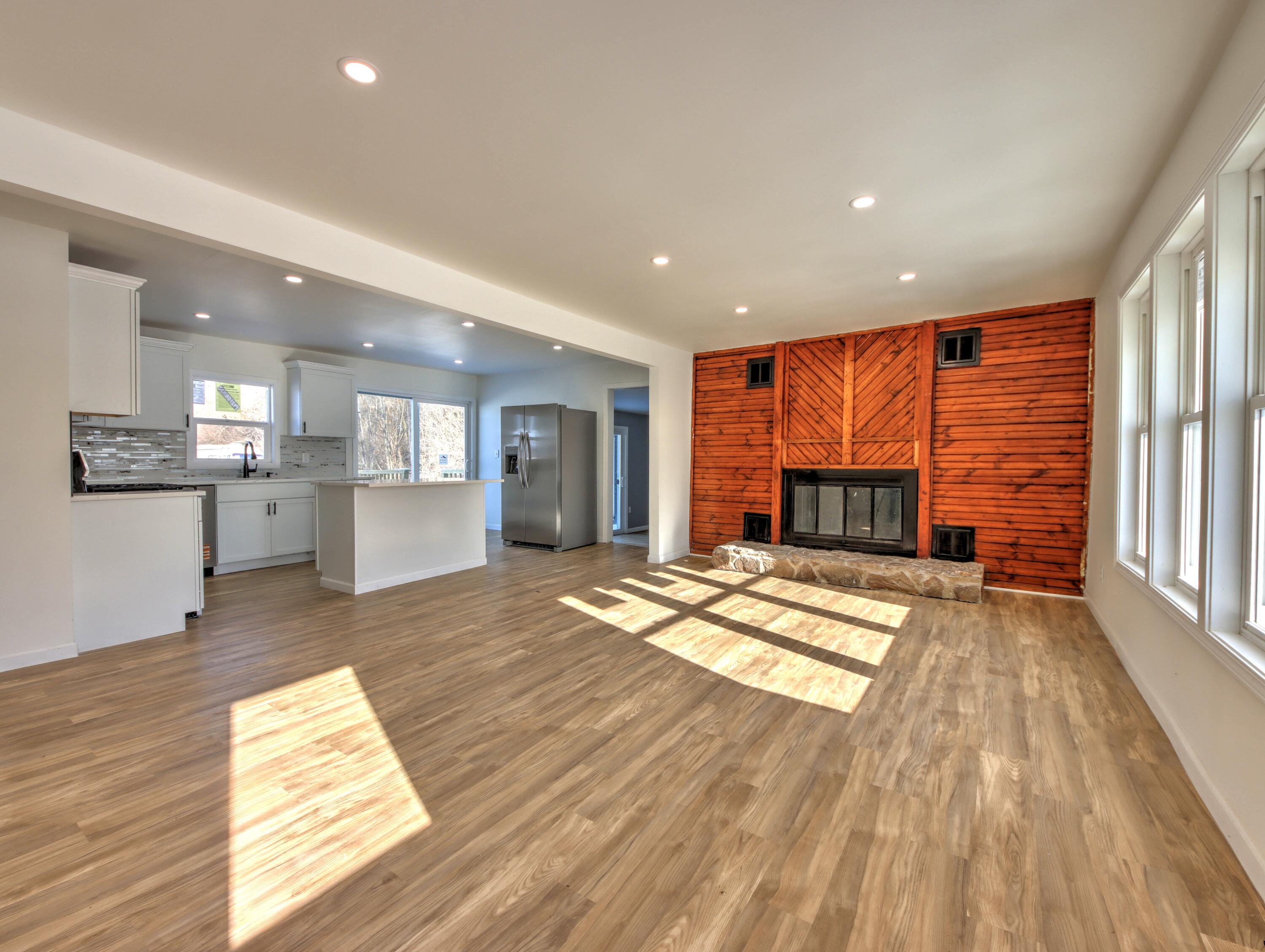 315 Holly Drive Walkerton, IN 46574 - Photo 4 of 33 a view of empty room with wooden floor and fireplace