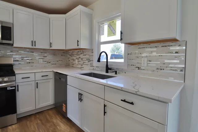 a kitchen with appliances cabinets and a sink