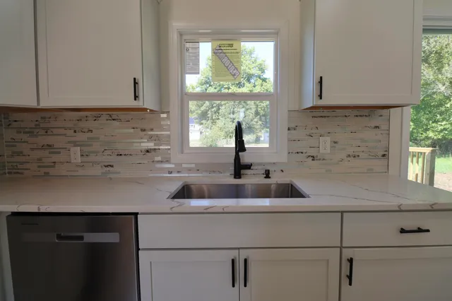 a kitchen with a sink and cabinets