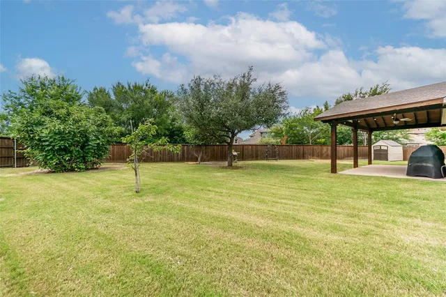 a house view with swimming pool and trees in the background