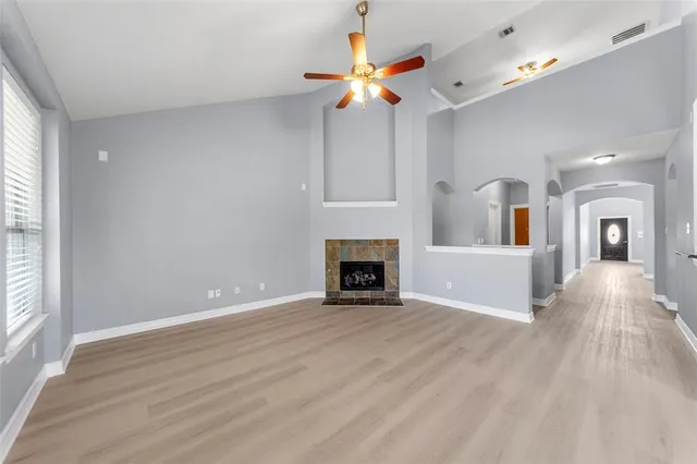 a view of a livingroom with a fireplace and window