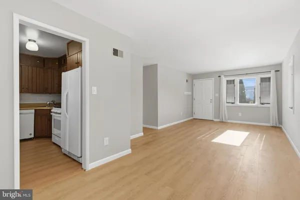 a view of a kitchen with a refrigerator and a stove top oven
