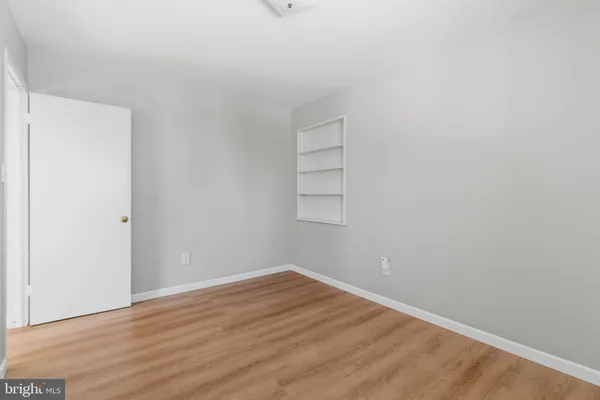 a view of a room with wooden floor