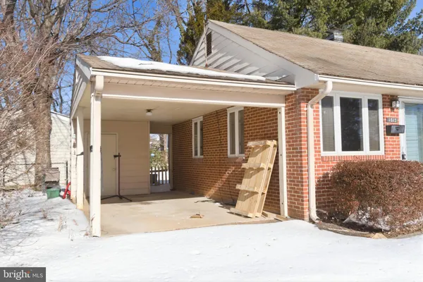 a view of a brick house with large windows