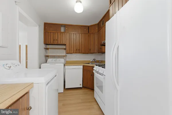 a utility room with cabinets washer and dryer