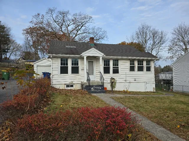 a front view of a house with a garden