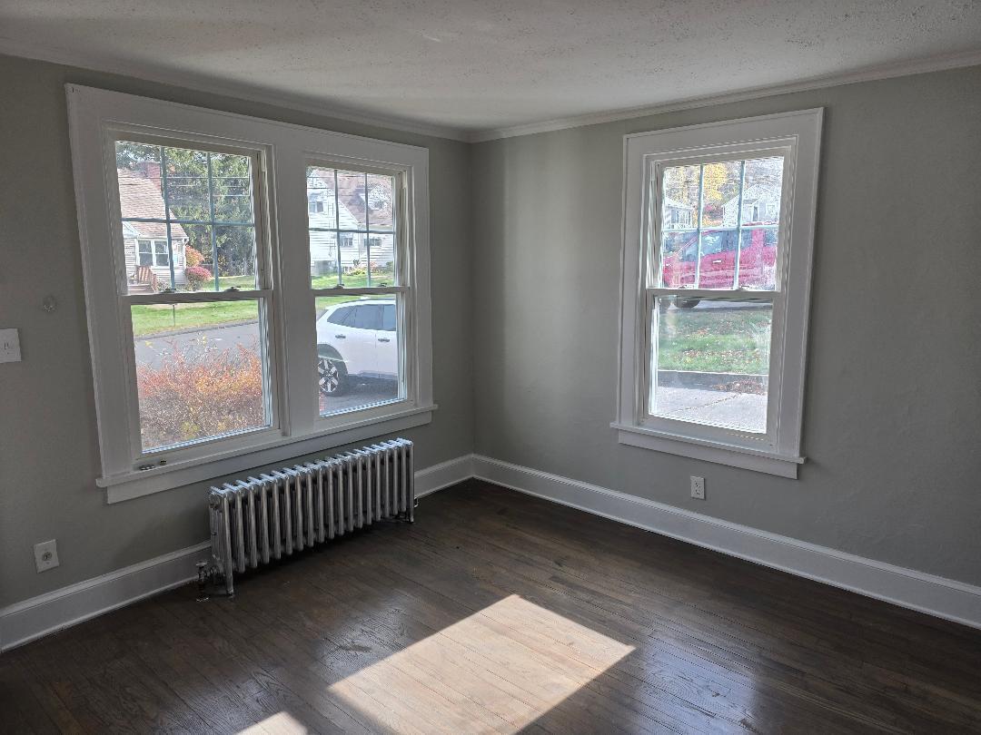 22 Holly Street Waterbury, CT 06706 - Photo 5 of 5 an empty room with wooden floor and windows