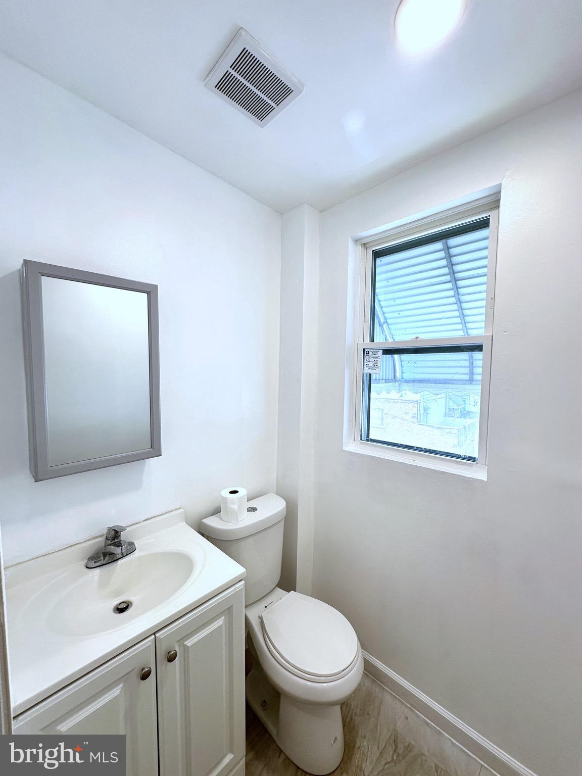 2600 South Mildred Street Philadelphia, PA 19148 - Photo 5 of 6 a bathroom with a toilet sink and mirror
