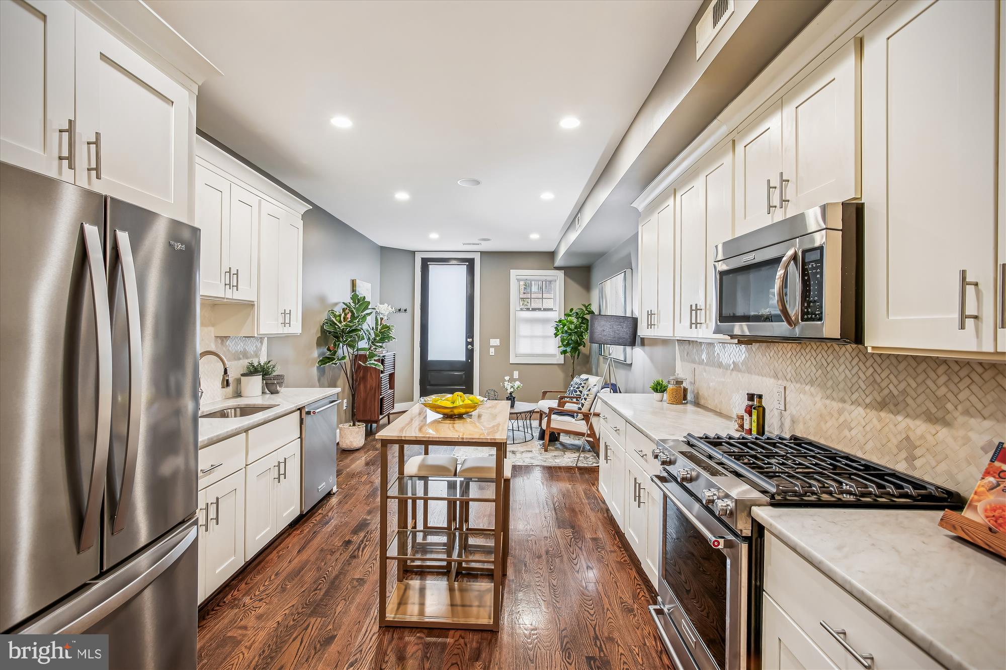 1521 9th Street Northwest Washington, DC 20001 - Photo 6 of 35 a kitchen with stainless steel appliances a refrigerator a stove a sink dishwasher a oven with white cabinets and wooden floor