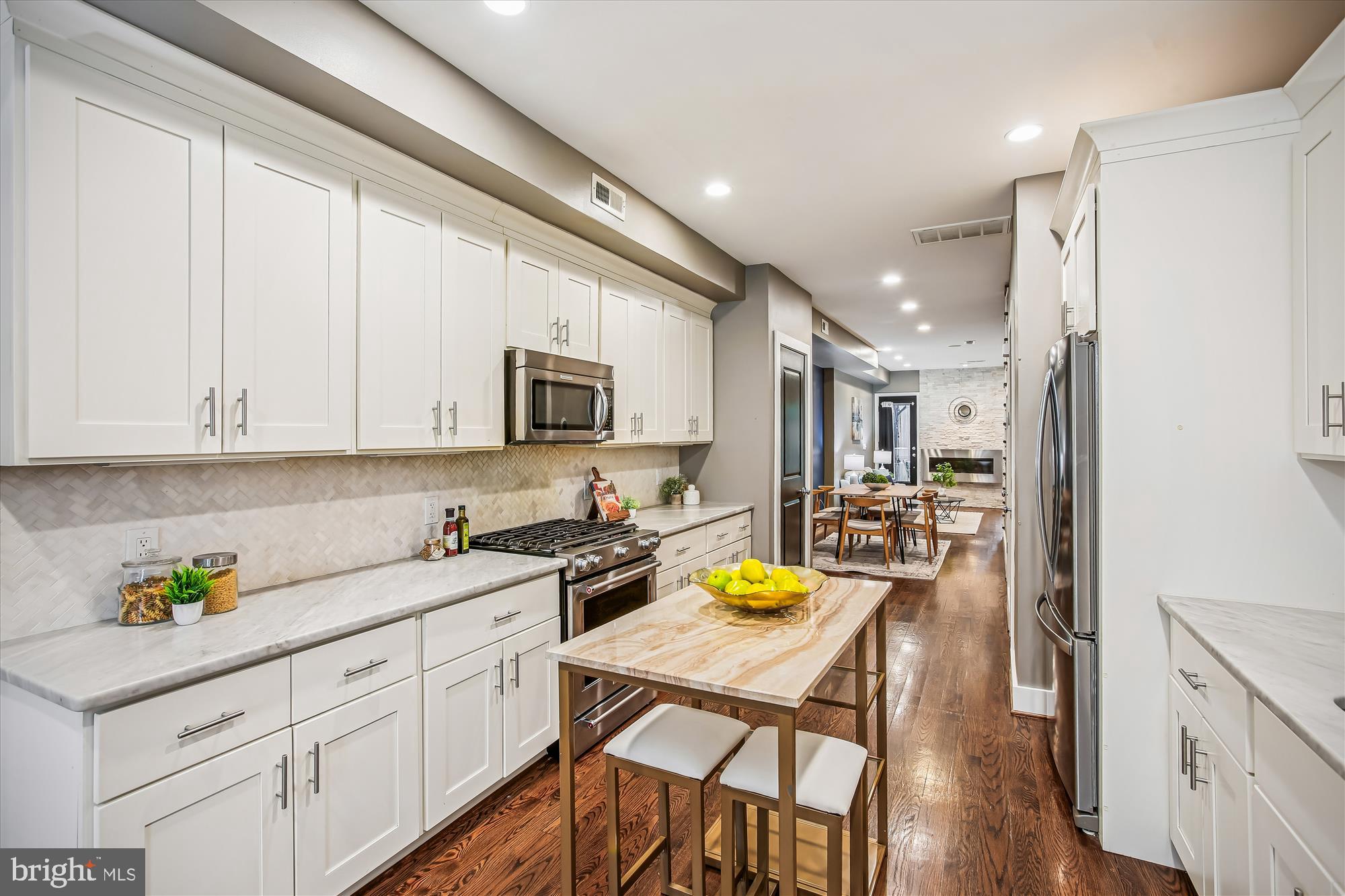 1521 9th Street Northwest Washington, DC 20001 - Photo 10 of 35 a kitchen with a sink white cabinets and stainless steel appliances