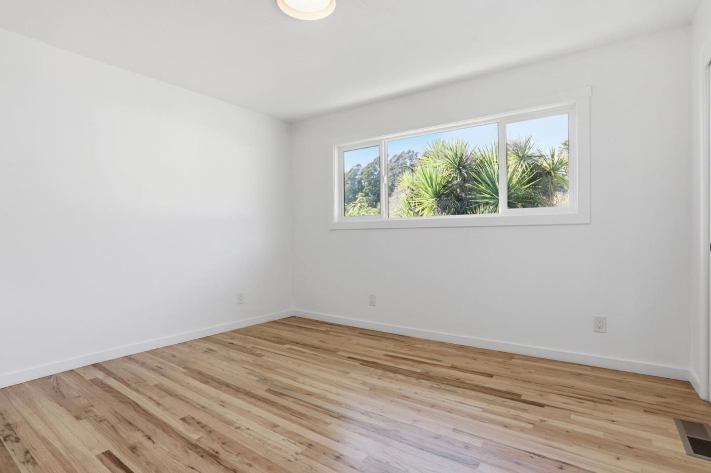 3233 Maplethorpe Lane Soquel, CA 95073 - Photo 12 of 35 an empty room with wooden floor and a window