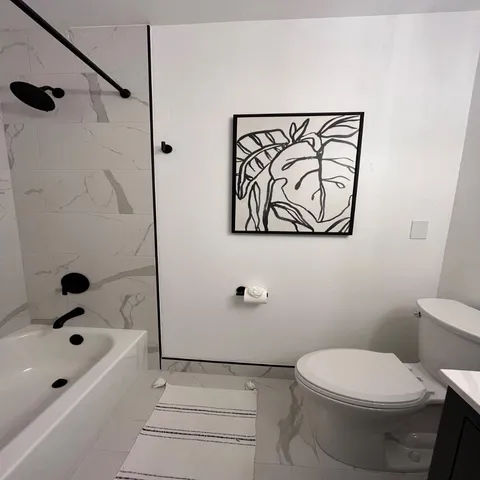 a bathroom with a toilet and a tub