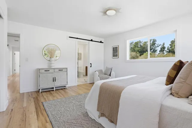 a bedroom with a bed and a chandelier