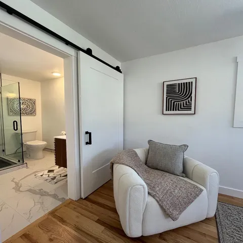 a bedroom with a bed and wooden floor