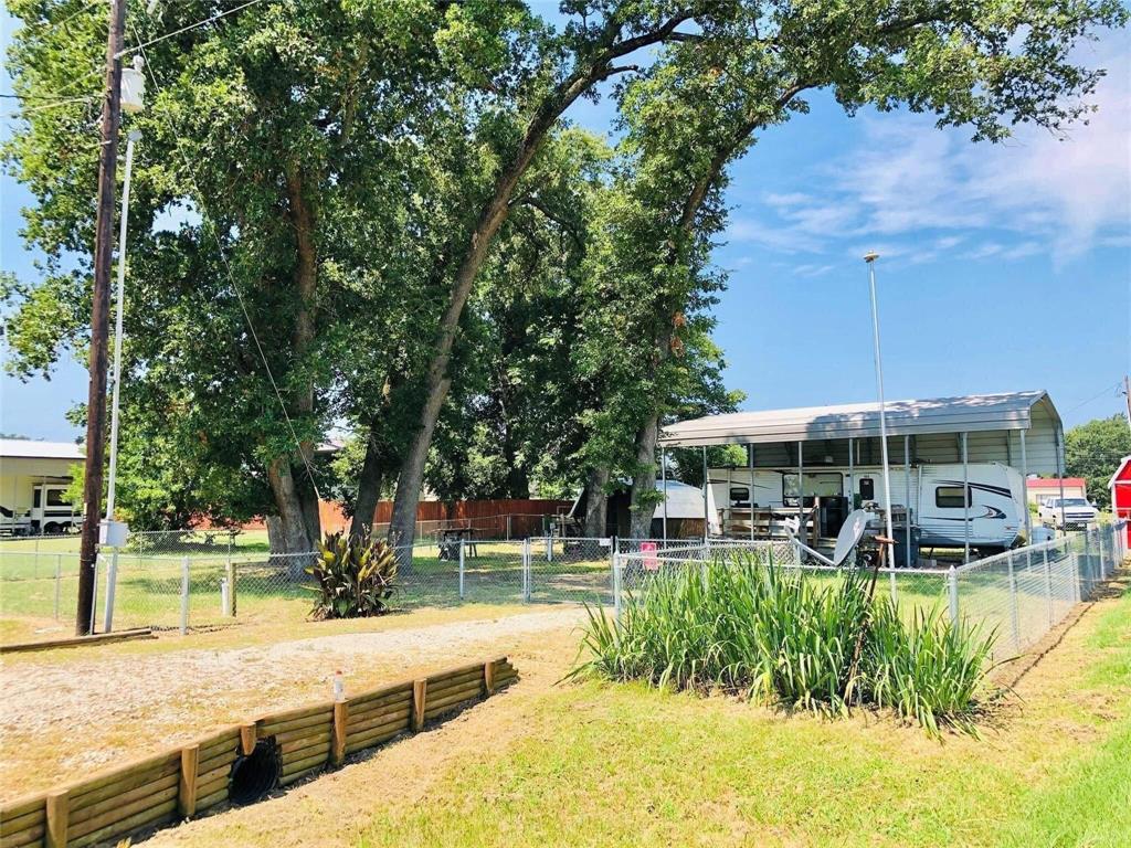 a view of a patio with table and chairs and potted plants