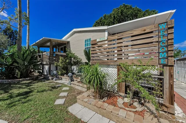 a view of a patio with table and chairs under an umbrella with wooden floor