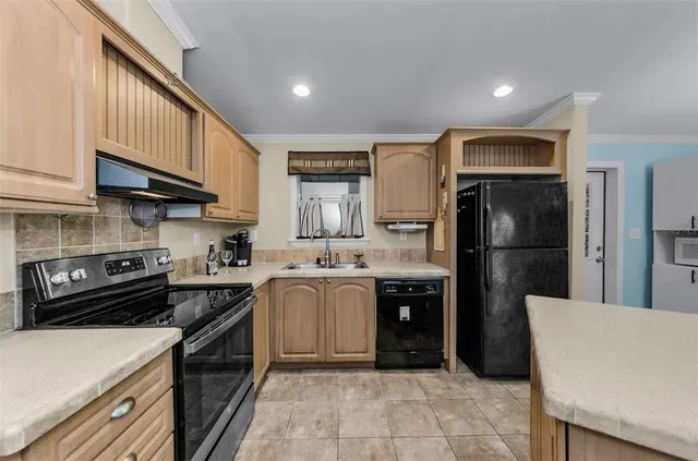 a kitchen with stainless steel appliances granite countertop a stove and a sink