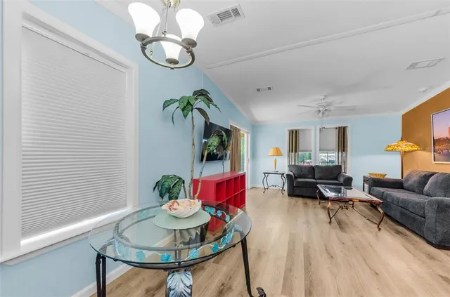 a view of a livingroom with furniture and a ceiling fan