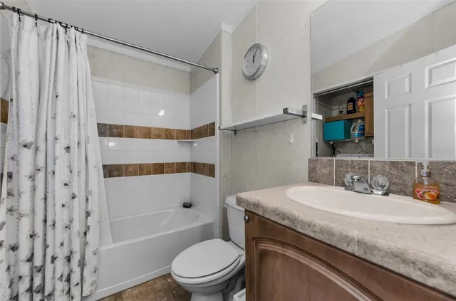 an aerial view of a house with wooden fence and trees