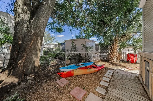 a backyard of a house with table and chairs