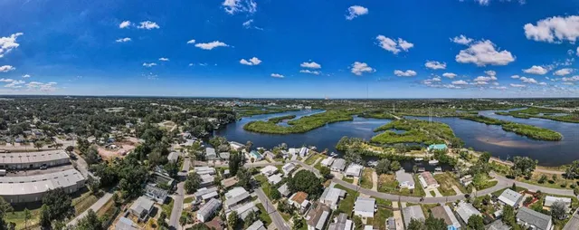 an aerial view of residential houses with outdoor space and river