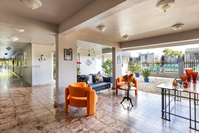 a view of a livingroom with furniture and floor to ceiling window