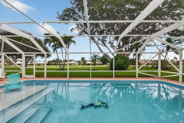 a view of a backyard with a swimming pool