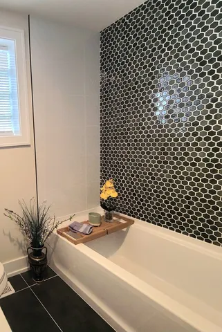 a bathroom with a bathtub and shower
