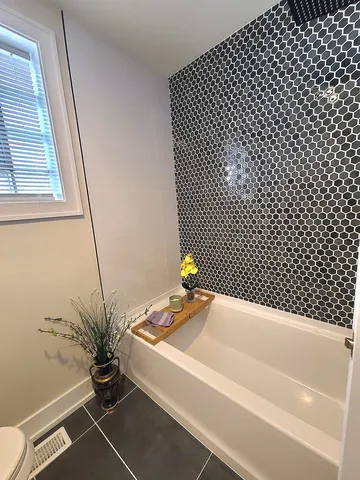 a bathroom with a bathtub and a shower