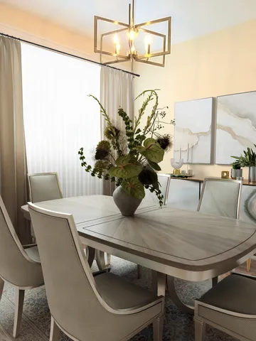 a dining table with a potted plant on wooden table and chairs