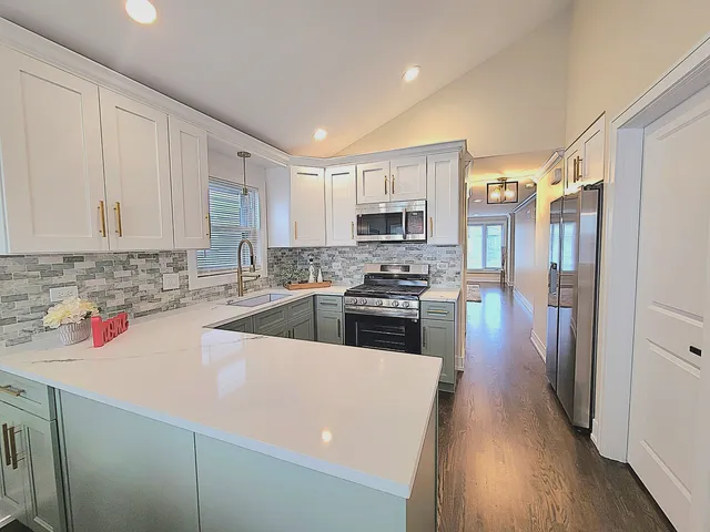 a kitchen with stainless steel appliances a refrigerator sink and cabinets