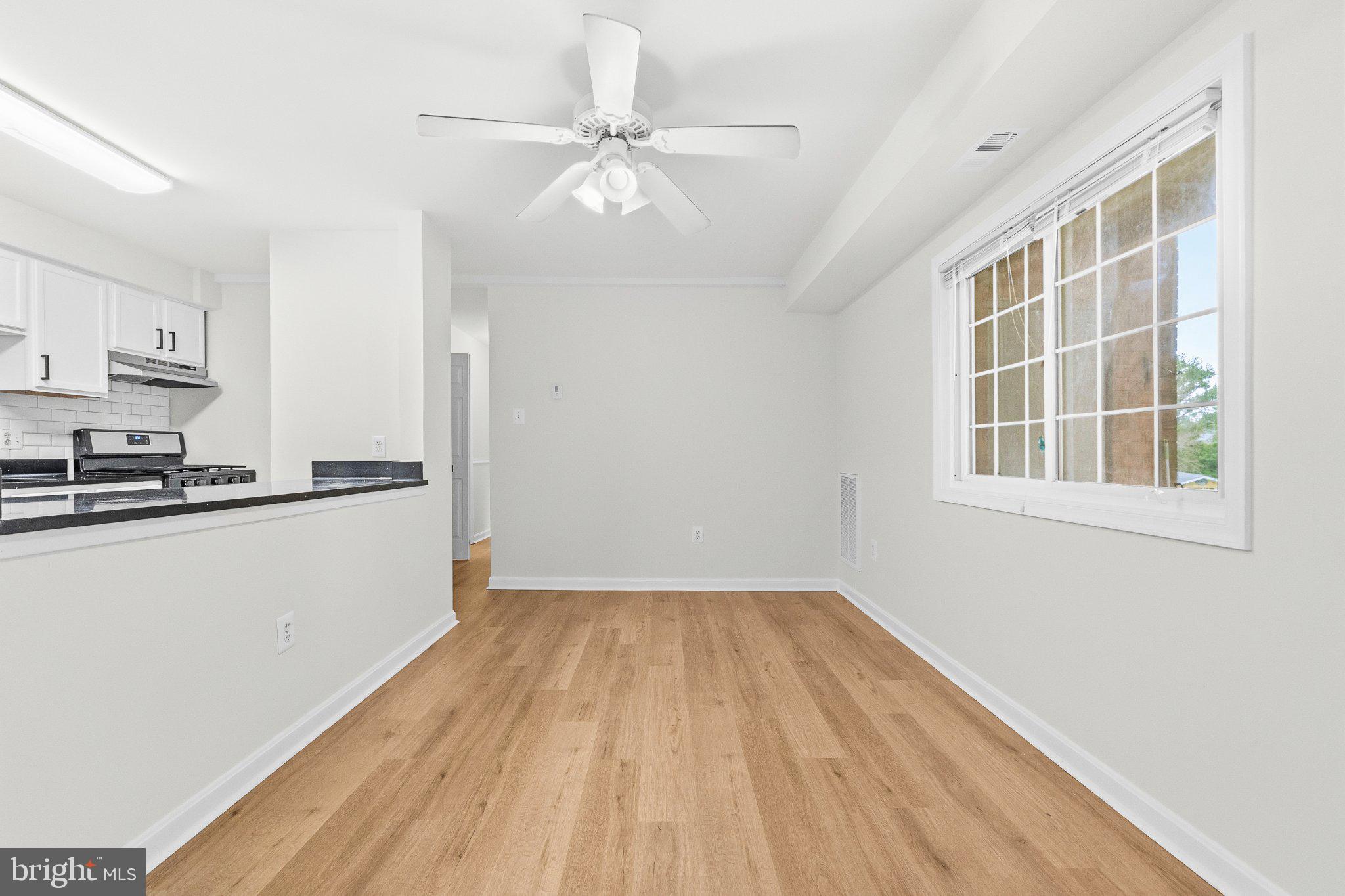 635 Waterloo Road, Unit 222 Warrenton, VA 20186 - Photo 12 of 33 a view of kitchen and empty room with wooden floor