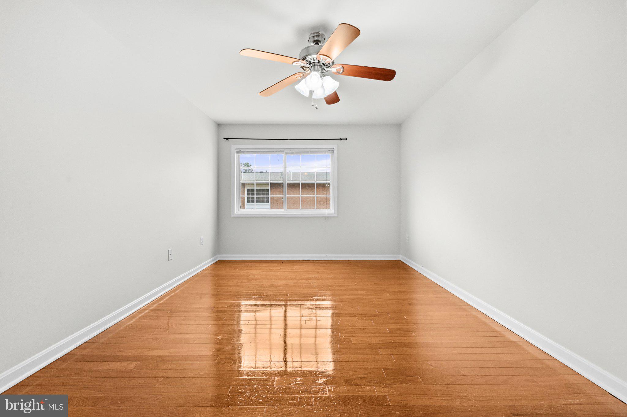 635 Waterloo Road, Unit 222 Warrenton, VA 20186 - Photo 27 of 33 an empty room with a window and a ceiling fan