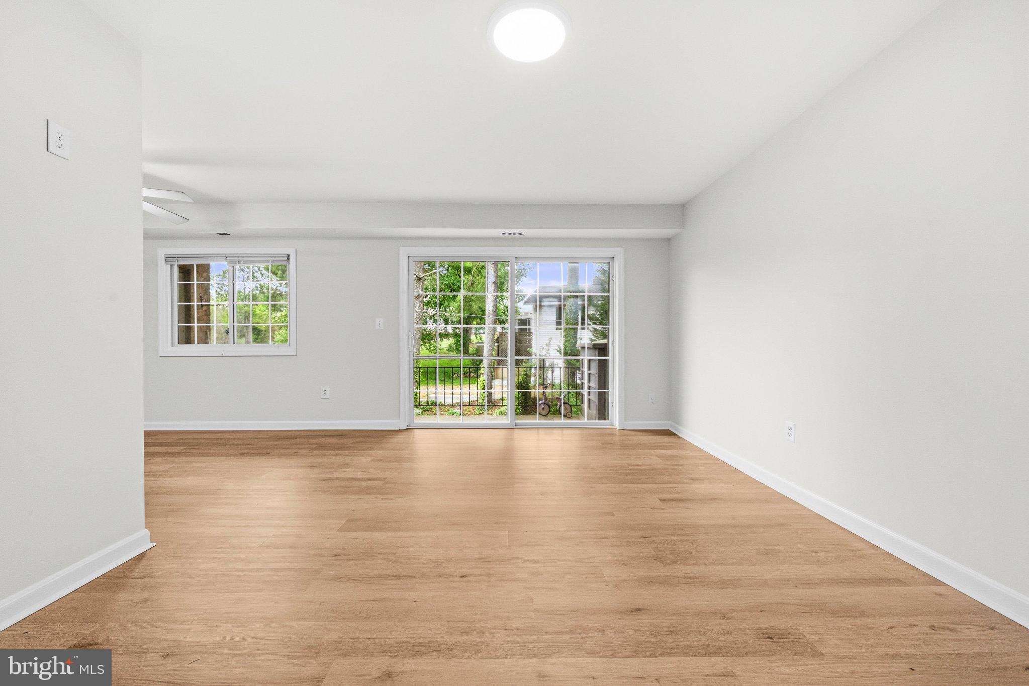 635 Waterloo Road, Unit 222 Warrenton, VA 20186 - Photo 9 of 33 a view of an empty room with wooden floor and a window
