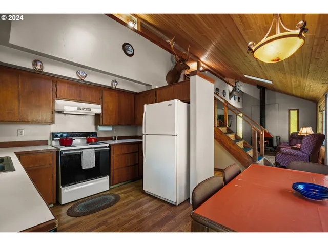 a kitchen with refrigerator and white cabinets