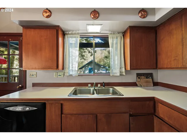 a kitchen with a sink and a window