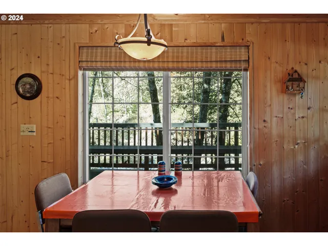 a view of a living room and floor to ceiling window or wooden floor