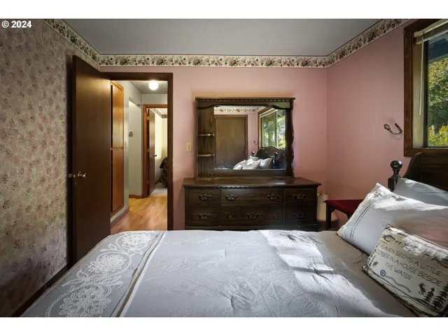 a bedroom with a bed and a dresser