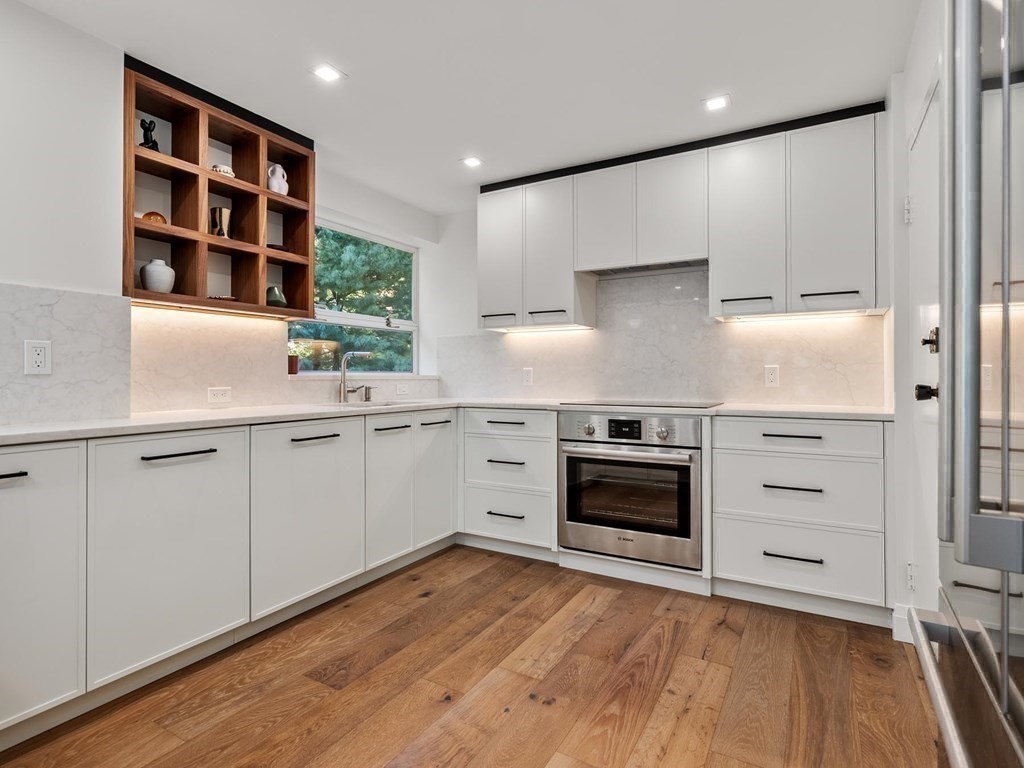 80 Park Street, Unit 24 Brookline, MA 02446 - Photo 17 of 17 a kitchen with a stove cabinets and wooden floor