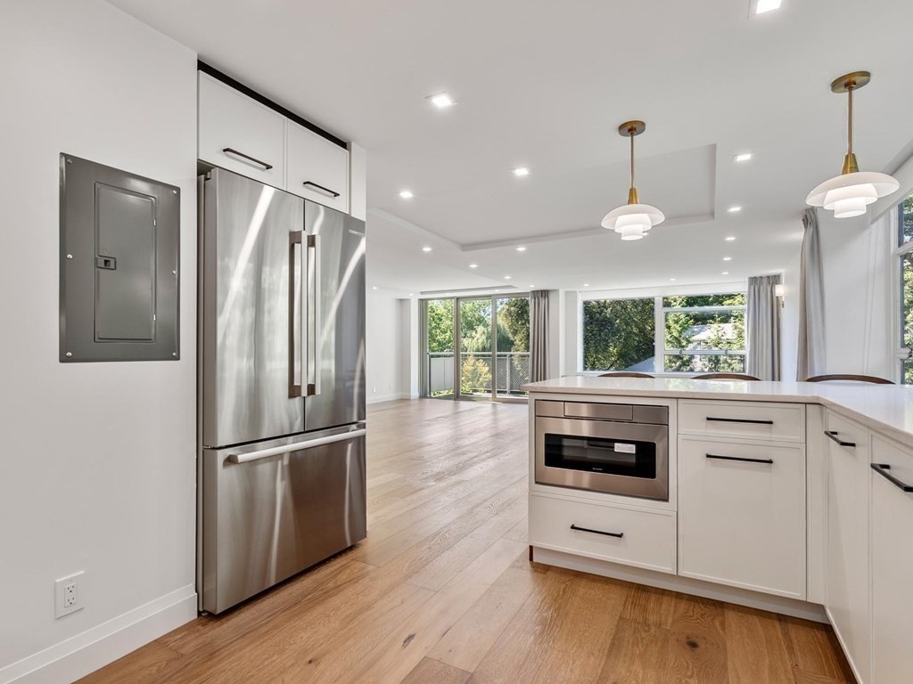 80 Park Street, Unit 24 Brookline, MA 02446 - Photo 4 of 17 a kitchen with stainless steel appliances a refrigerator sink and microwave