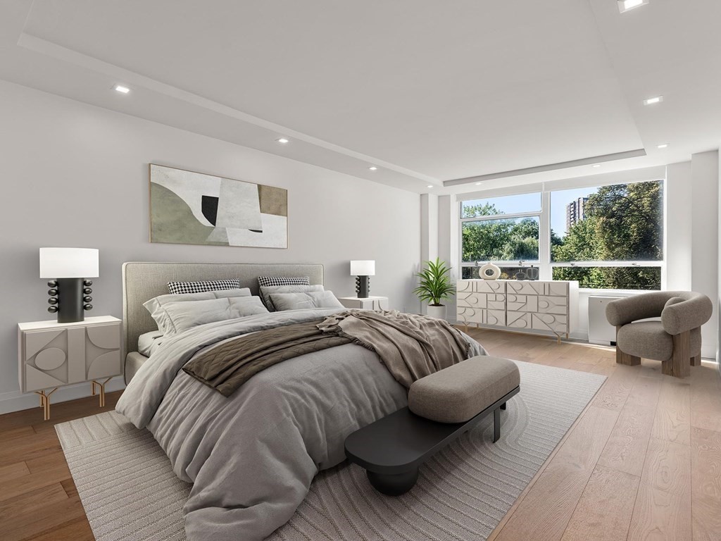 80 Park Street, Unit 24 Brookline, MA 02446 - Photo 10 of 17 a bedroom with a bed and glass window