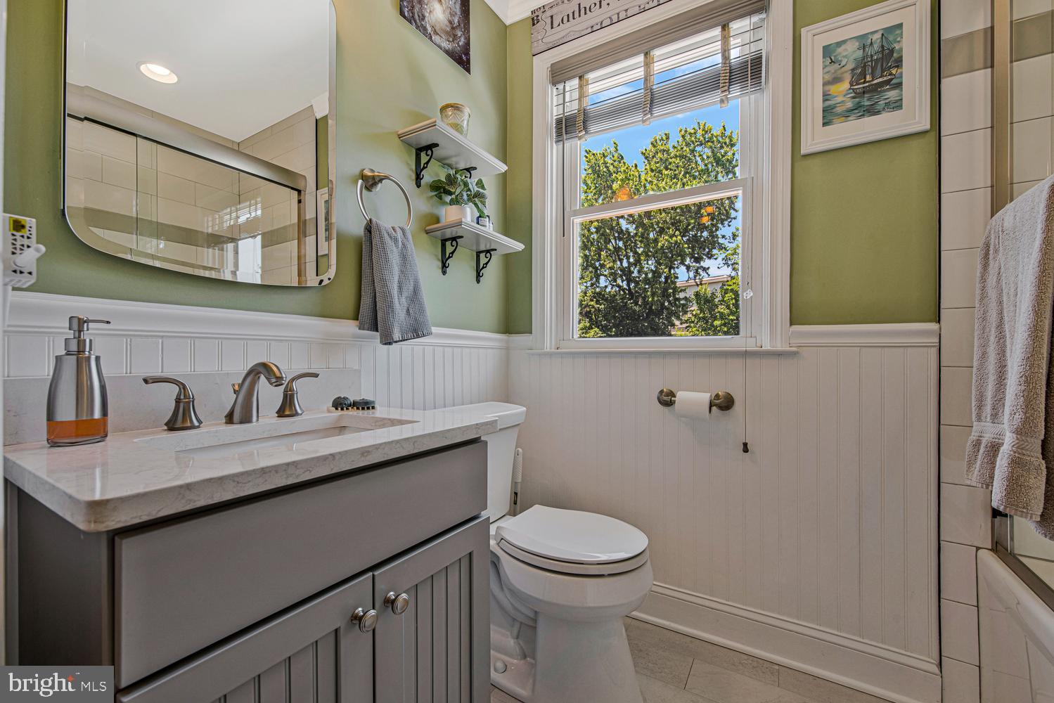 902 Locustvale Road Towson, MD 21204 - Photo 21 of 35 a bathroom with a granite countertop sink toilet and mirror