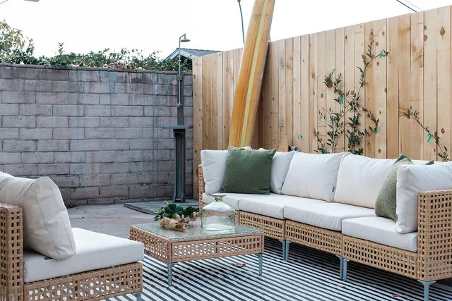 a living room with furniture and a potted plant