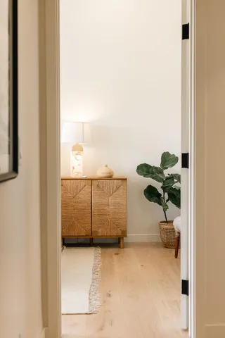a bed sitting in a room next to a window