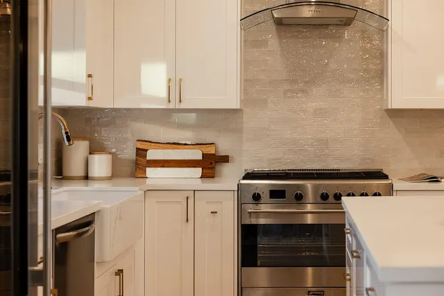a kitchen with a stove and a white cabinet
