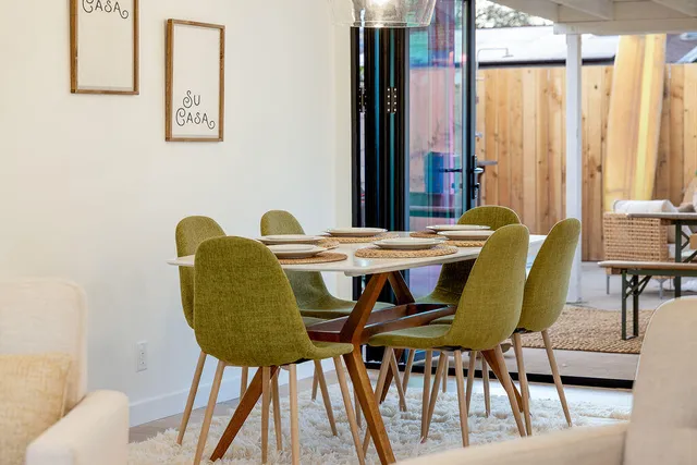 a view of a dining room with furniture and a window