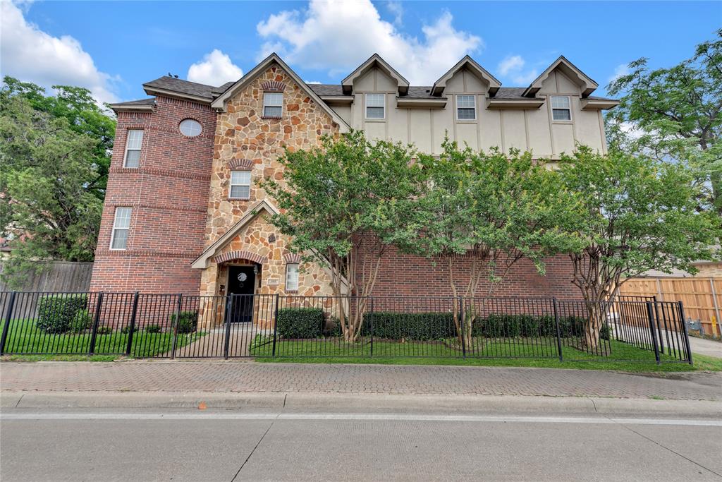 Three-story townhome featuring a stone and brick facade
