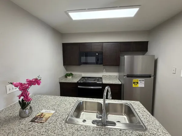 a kitchen with a sink cabinets and granite counter top