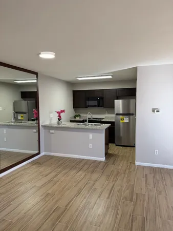 a bathroom with a granite countertop sink toilet a large mirror and shower